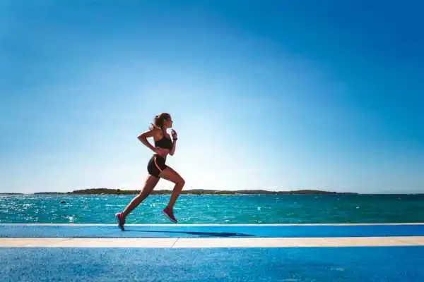 Woman running showing strong leg muscle Halesowen